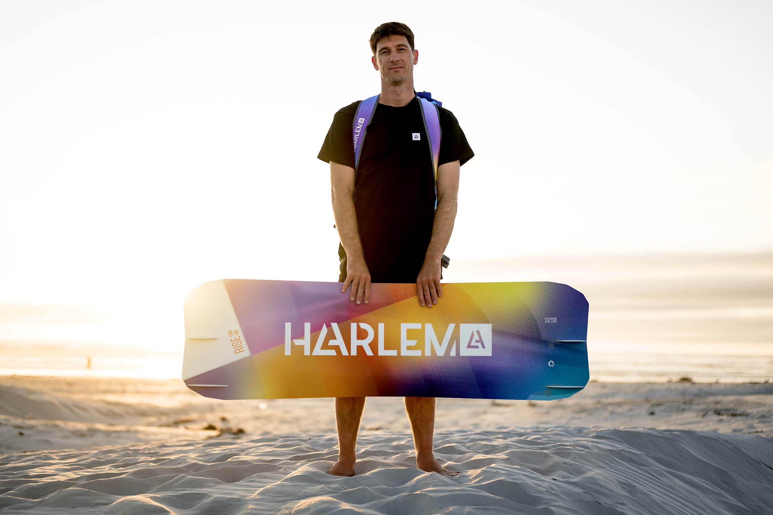 Aaron hadlow holding the harlem rise kiteboard